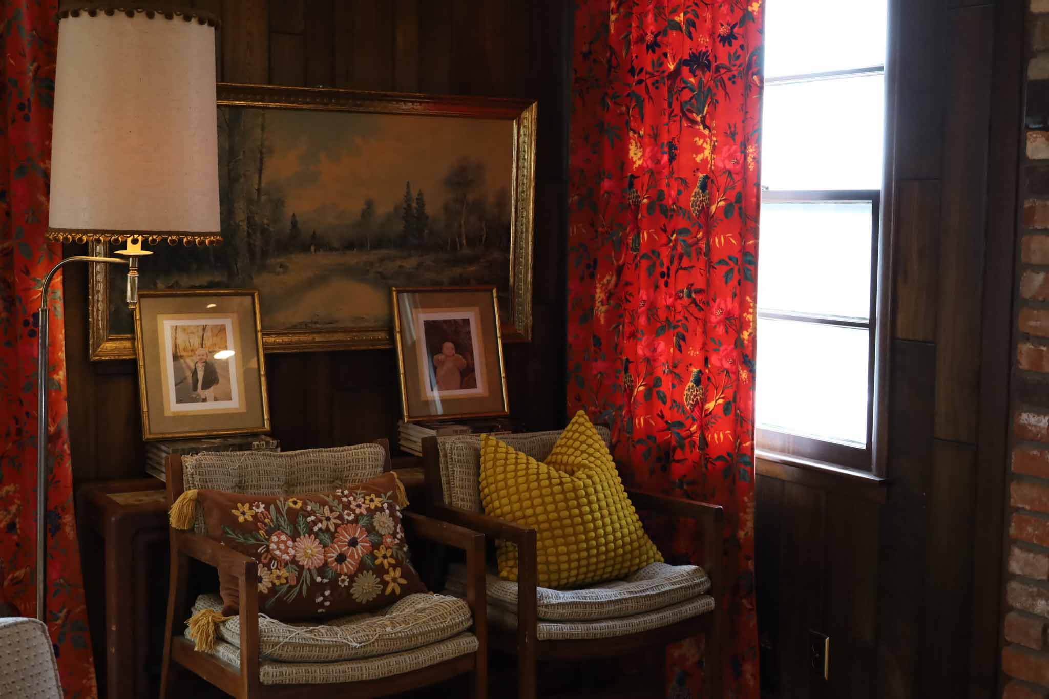 Living room with curated art and bold curtains