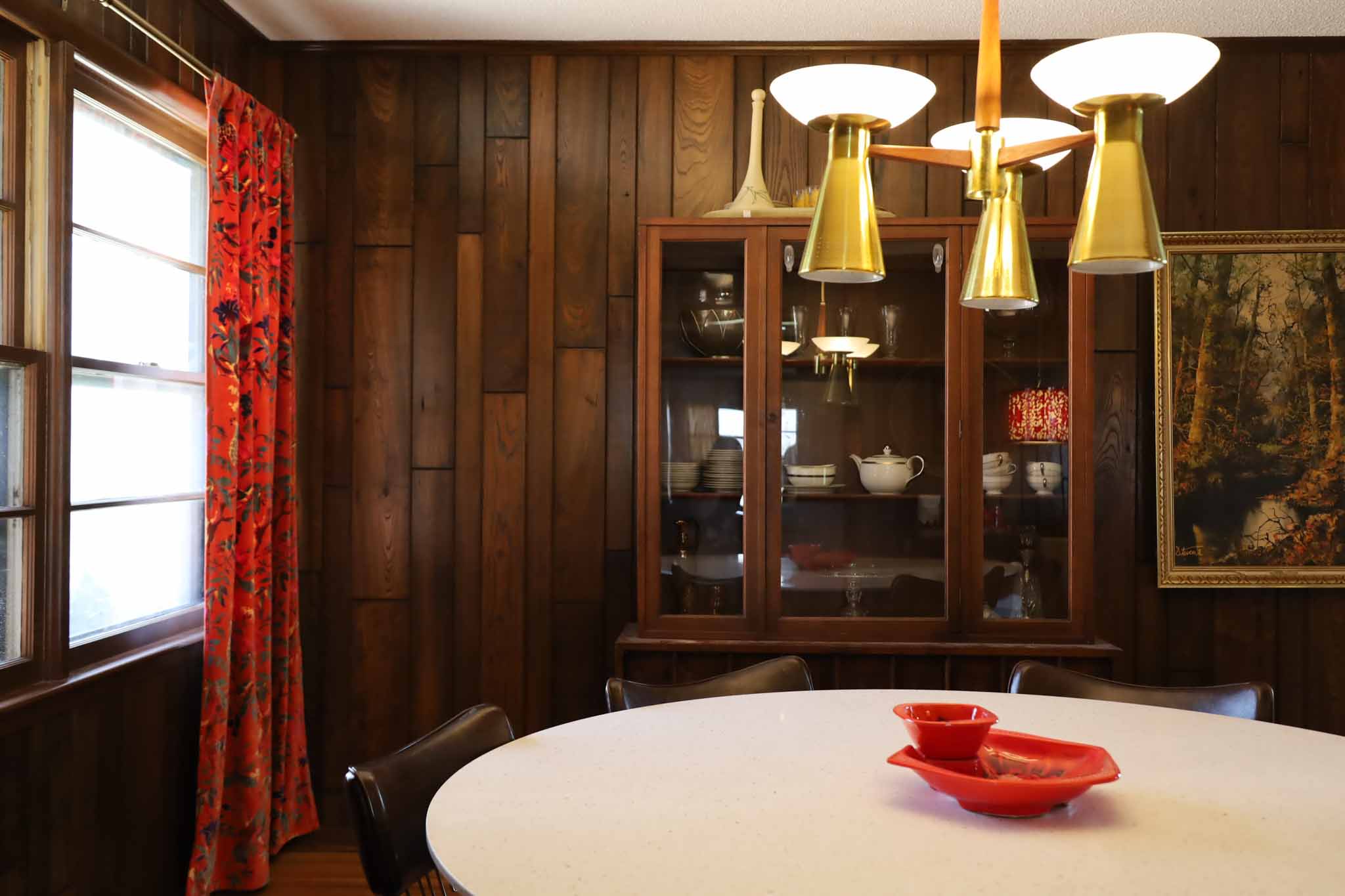Dining room with brass chandelier and china cabinet