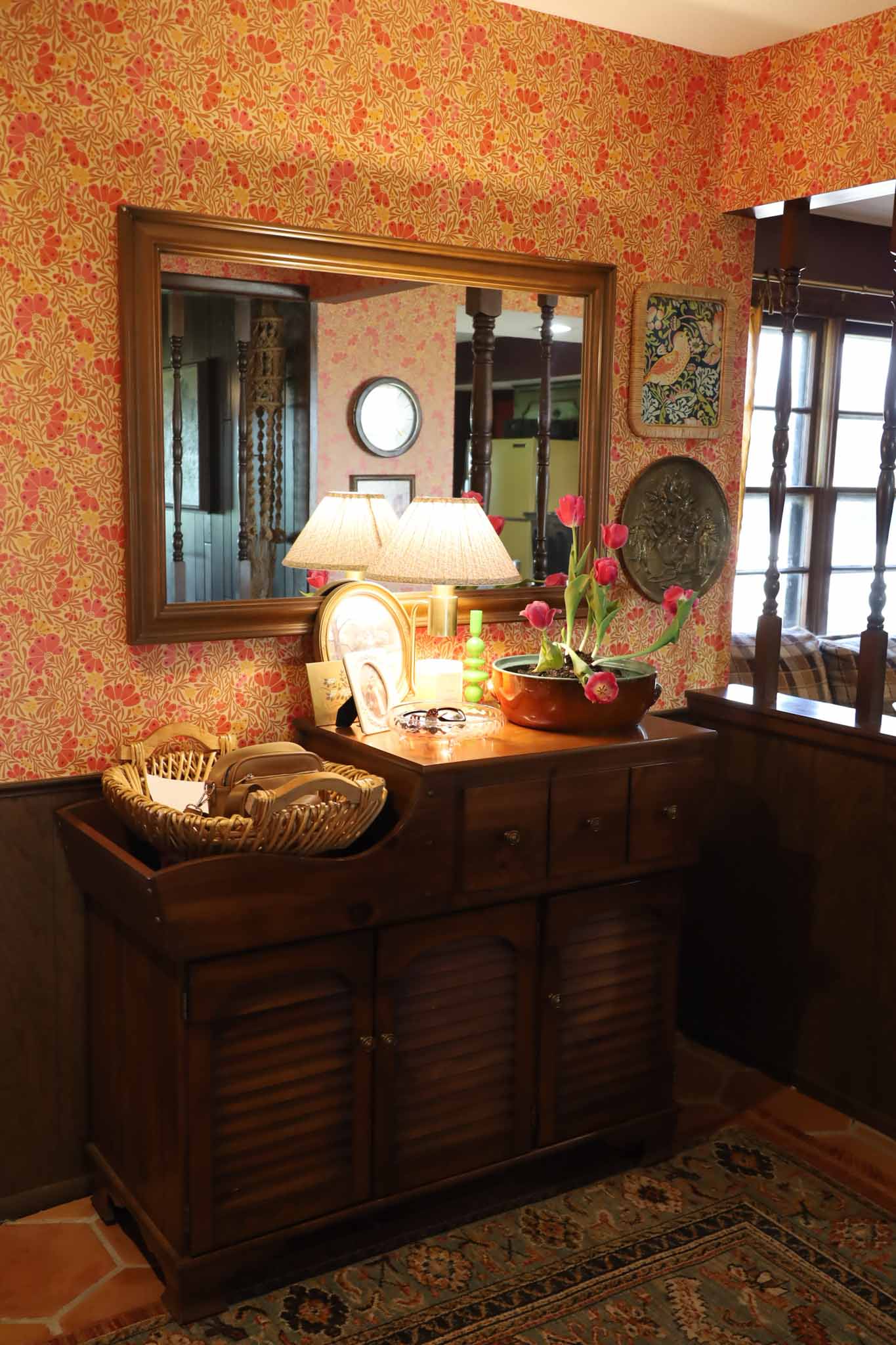 Entryway with floral wallpaper and vintage secretary desk