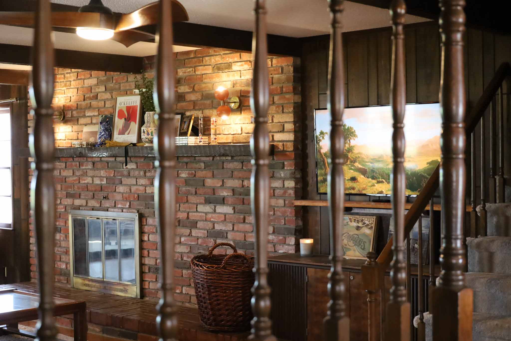 Brick fireplace through staircase spindles